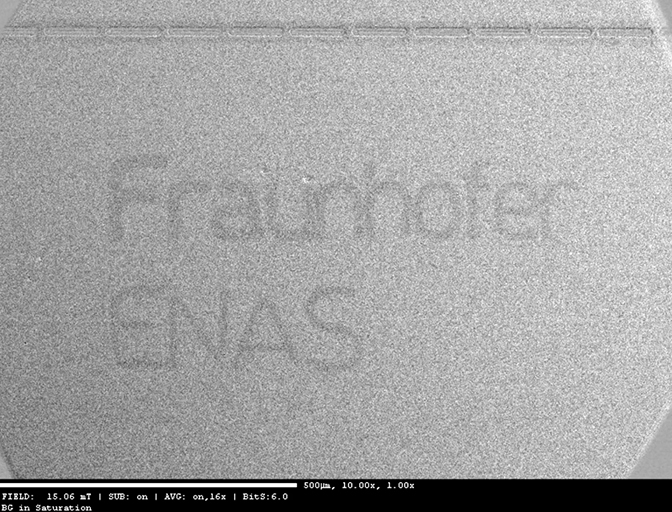 Laser defined magnetic contrast from a 5 nm thick CoFeB film on the basis of the exchange bias effect. The logo is visible in a limited magnetic field range only, here H=15 mT was applied.