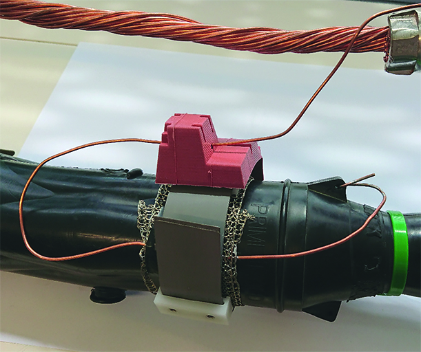 Prototype mounted at cable joint in lab. Prototype mounted at cable joint in lab.